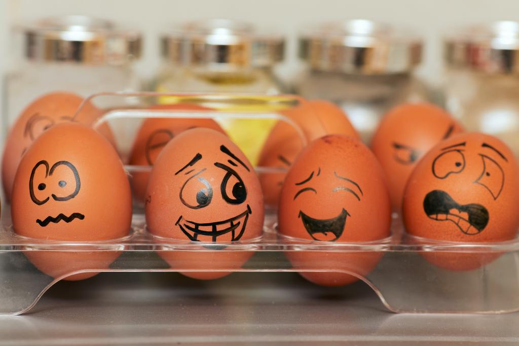 A picture of eggs with vaguely hysterical faces drawn on them.
